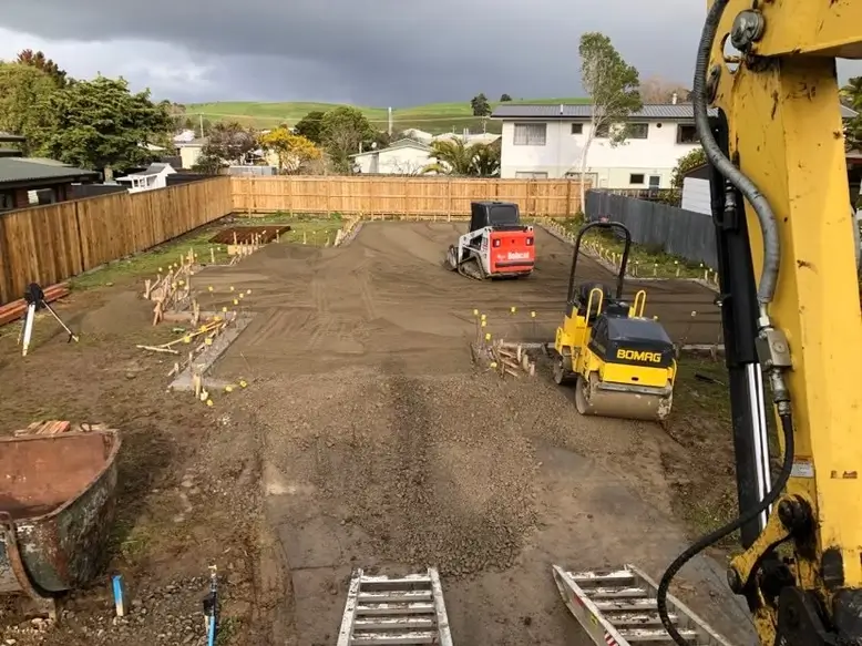 Workers clearing and preparing the area for concrete pouring — by Manawatu Concrete.