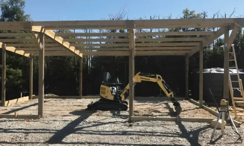 Installation of a new concrete patios in progress, featuring freshly poured concrete being smoothed out and leveled by skilled workers — by Manawatu Concrete.